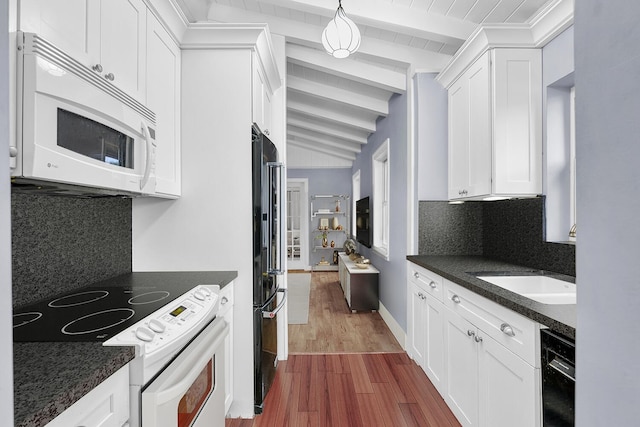 kitchen featuring hardwood / wood-style floors, backsplash, black appliances, white cabinets, and sink