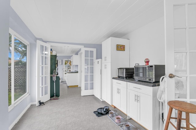 kitchen featuring white cabinetry and french doors