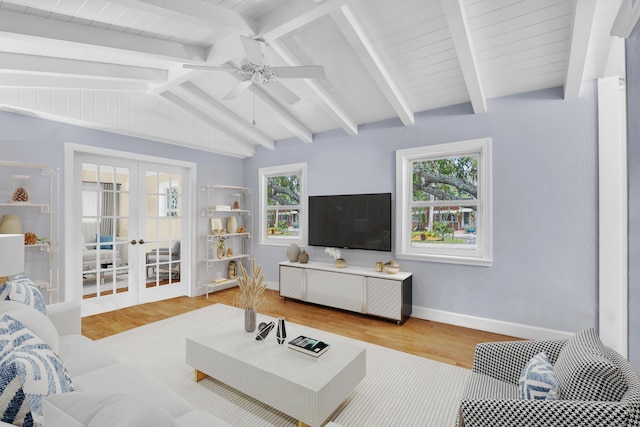 living room featuring hardwood / wood-style flooring, ceiling fan, french doors, and vaulted ceiling with beams