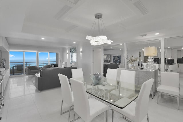 dining room featuring an inviting chandelier, light tile patterned floors, a water view, and coffered ceiling