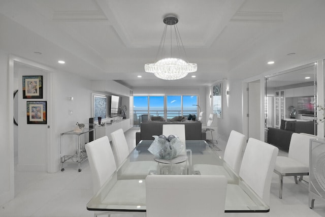 tiled dining space featuring an inviting chandelier and crown molding