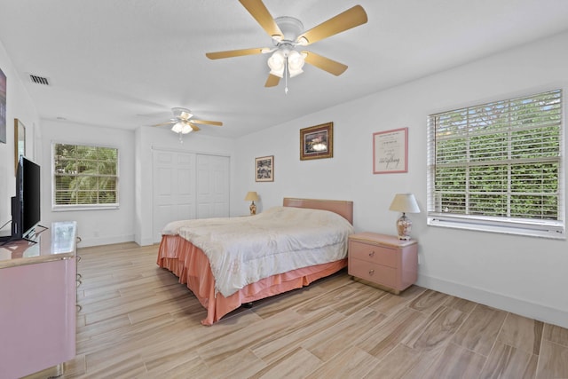 bedroom featuring ceiling fan and a closet