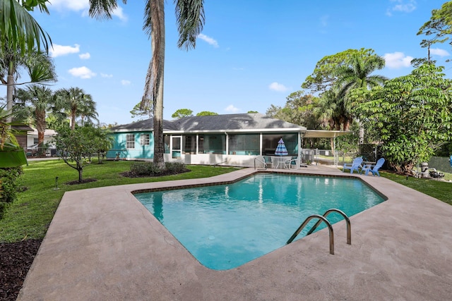 view of pool featuring a sunroom, a lawn, and a patio