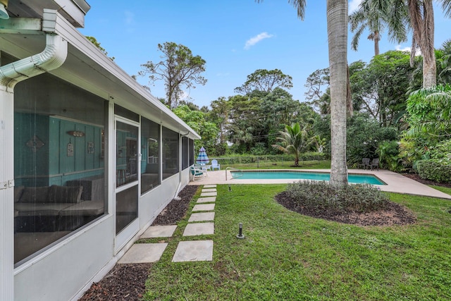 view of yard with a sunroom and a patio