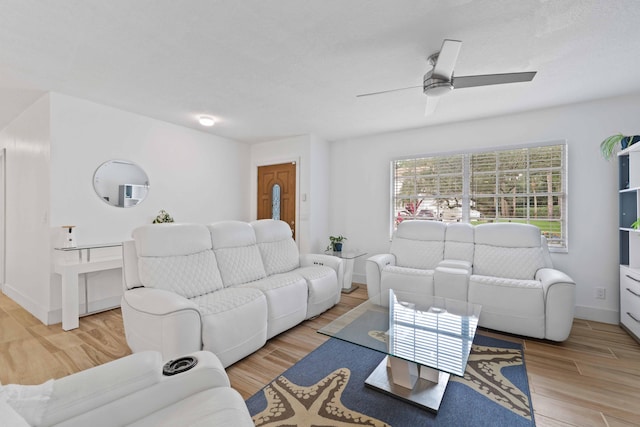 living room featuring ceiling fan and light hardwood / wood-style floors