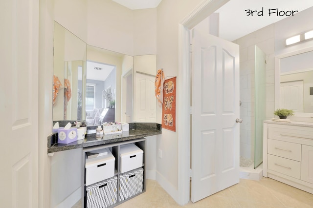 bathroom featuring tile patterned floors and vanity