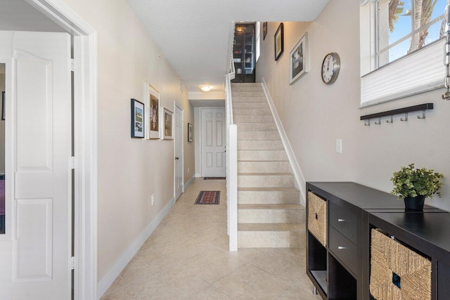 corridor featuring light tile patterned floors