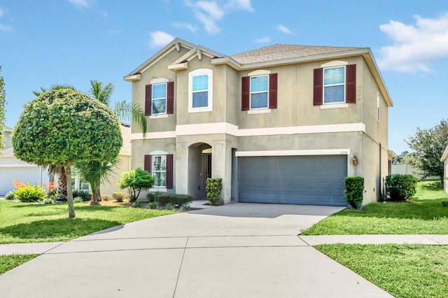 view of front of property with a front yard and a garage