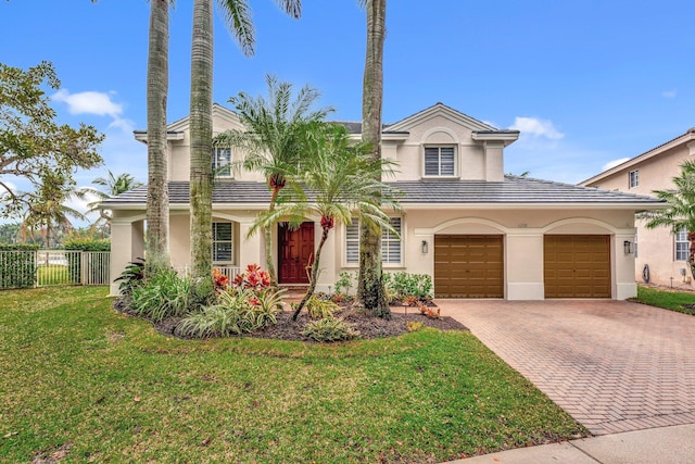 view of front of property with a garage and a front lawn