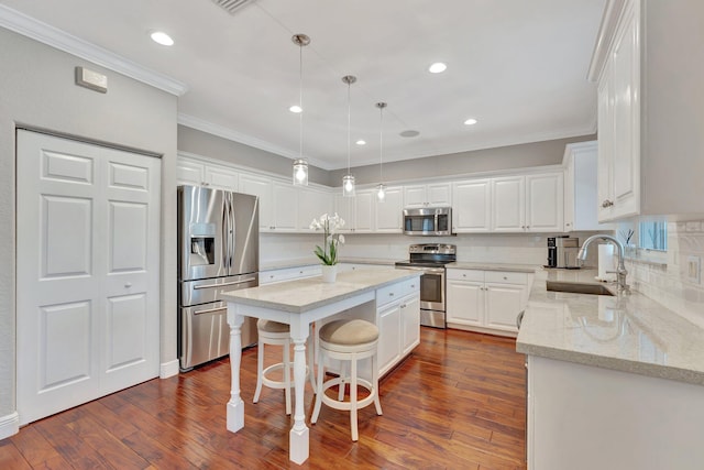 kitchen featuring a kitchen island, appliances with stainless steel finishes, sink, and white cabinets