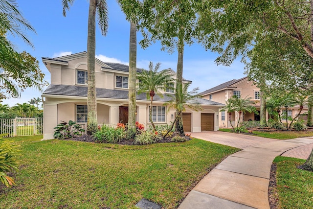 view of front of property featuring a garage and a front yard