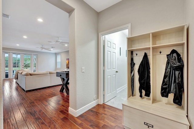 mudroom featuring dark wood-type flooring and ceiling fan