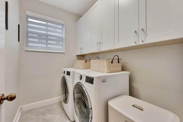 laundry room with cabinets and washing machine and clothes dryer