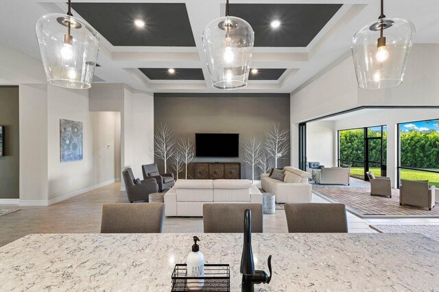 living room featuring ornamental molding, a towering ceiling, coffered ceiling, and beamed ceiling