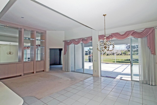 unfurnished dining area with light colored carpet and a notable chandelier