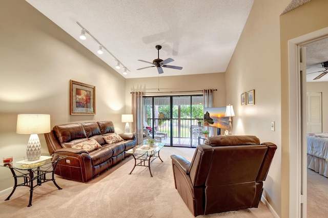 carpeted living room with ceiling fan and a textured ceiling