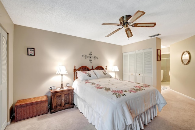 carpeted bedroom featuring ceiling fan, a closet, and a textured ceiling