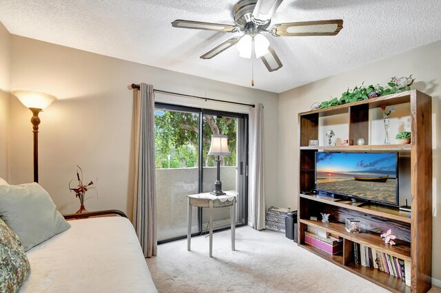 bedroom with a textured ceiling, ceiling fan, and carpet floors