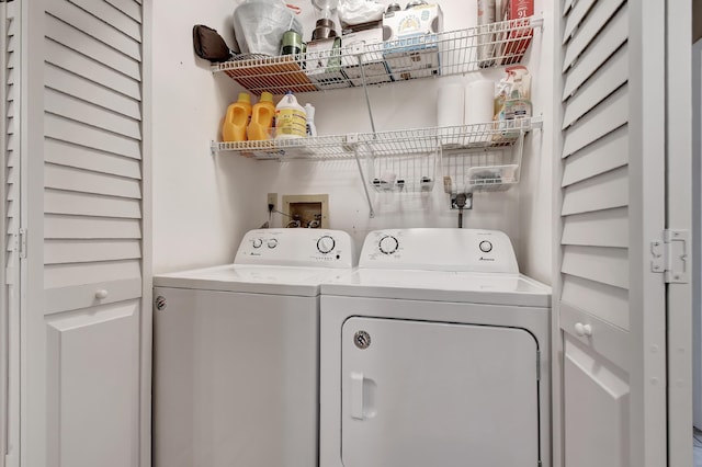 clothes washing area with separate washer and dryer