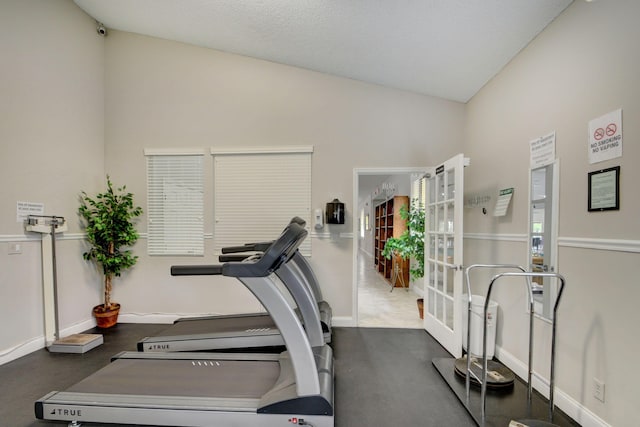 workout room with lofted ceiling and french doors