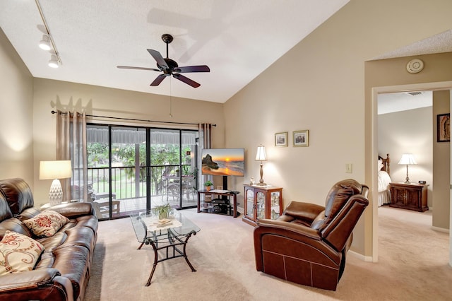 carpeted living room featuring ceiling fan, rail lighting, and vaulted ceiling