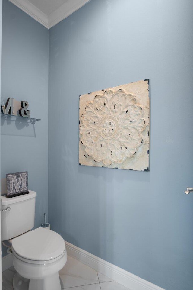 bathroom featuring toilet and ornamental molding