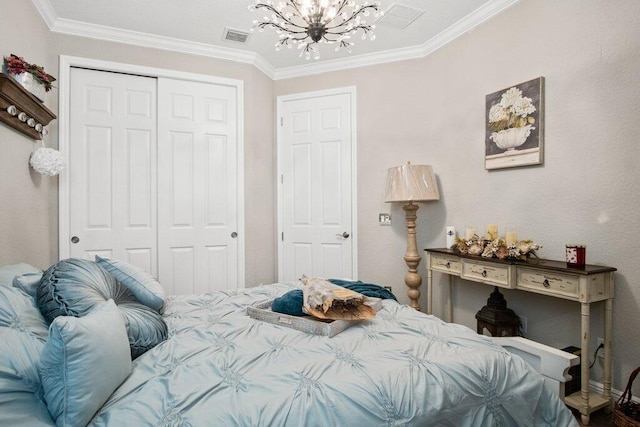 bedroom featuring a chandelier, a closet, and ornamental molding