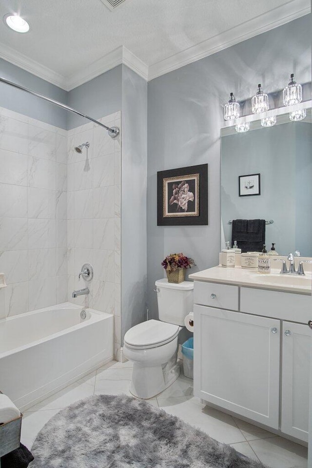 full bathroom featuring toilet, vanity, ornamental molding, and tiled shower / bath