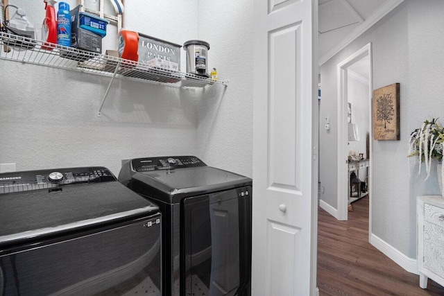 laundry area with washing machine and dryer and dark wood-type flooring