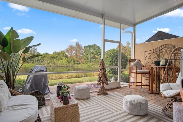 sunroom / solarium featuring a water view