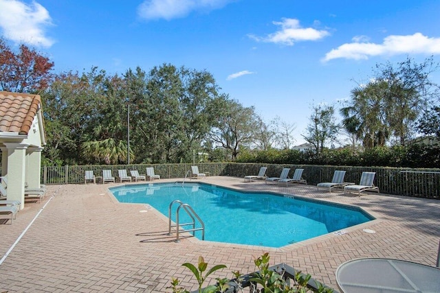 view of swimming pool featuring a patio area