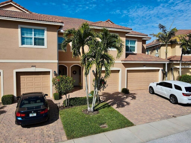 mediterranean / spanish-style home with a garage