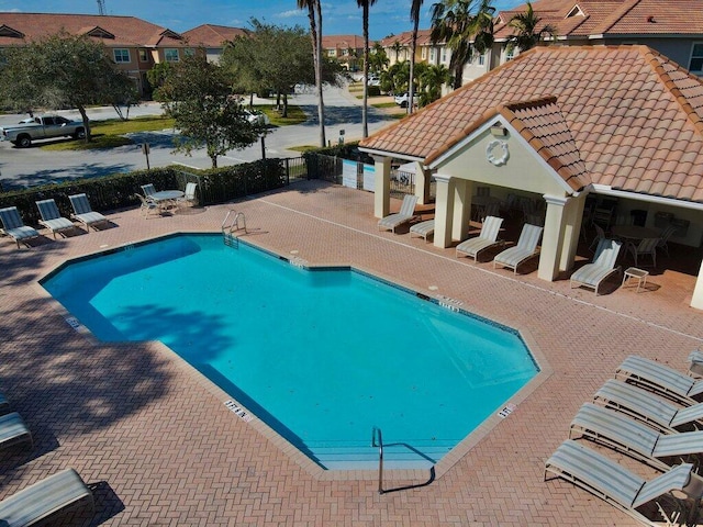 view of pool with a patio area and an outdoor structure