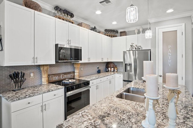 kitchen featuring appliances with stainless steel finishes, decorative backsplash, and white cabinetry