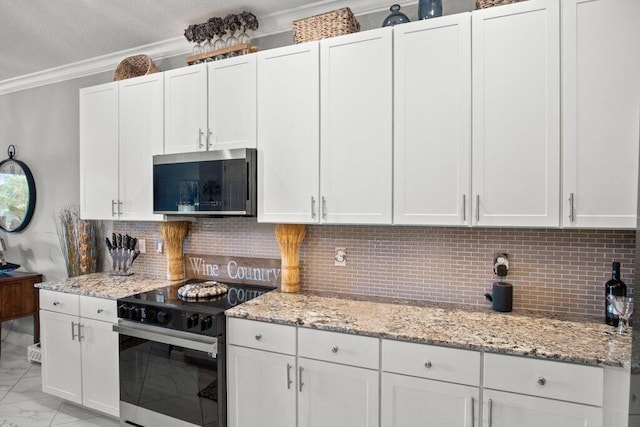 kitchen featuring light stone countertops, white cabinetry, black electric range oven, and tasteful backsplash