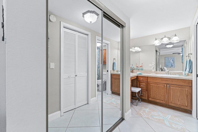 bathroom featuring tile patterned floors, toilet, and vanity