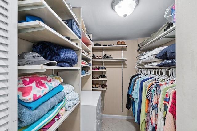 spacious closet featuring light tile patterned floors