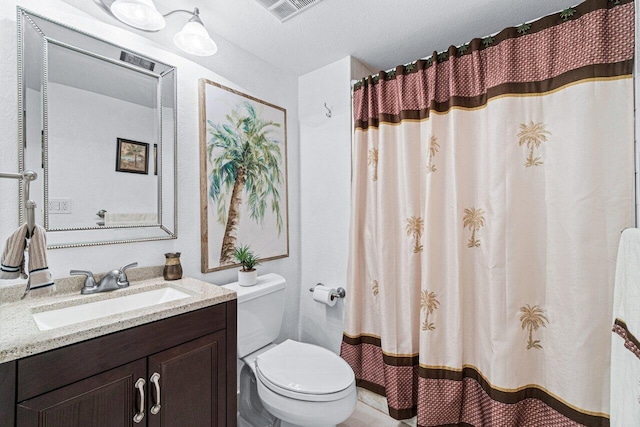 bathroom with a textured ceiling, toilet, vanity, and a shower with curtain