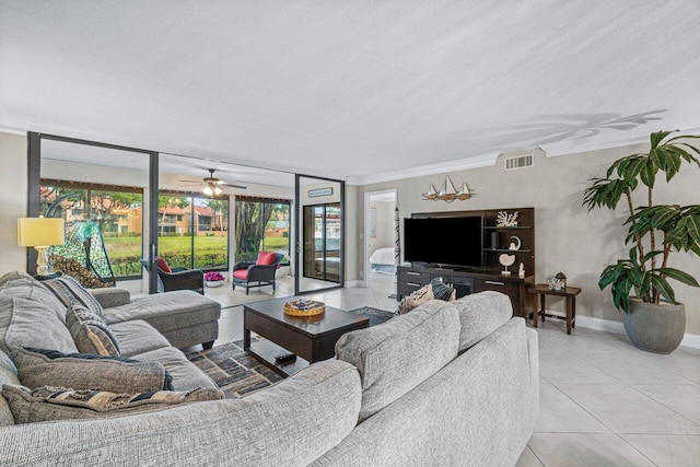 tiled living room with ceiling fan and plenty of natural light