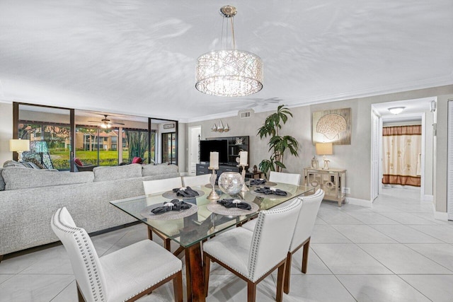 tiled dining room featuring ceiling fan with notable chandelier and crown molding