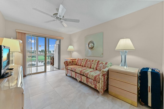 living room with ceiling fan and light tile patterned floors