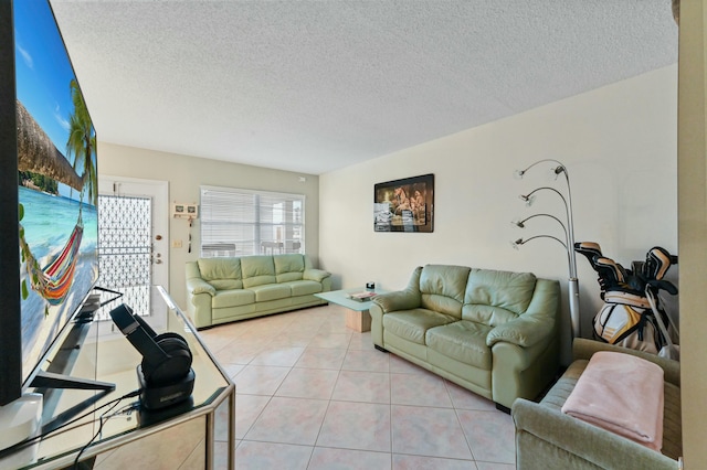 living room with a textured ceiling and light tile patterned flooring