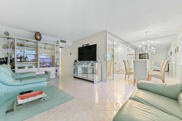 tiled living room with a textured ceiling and a chandelier