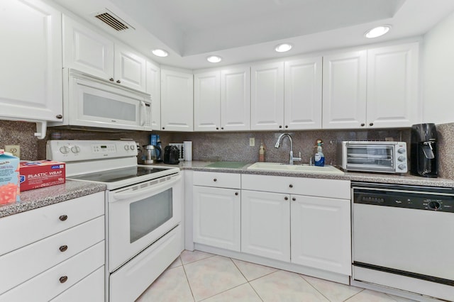 kitchen featuring white cabinetry, sink, tasteful backsplash, and white appliances