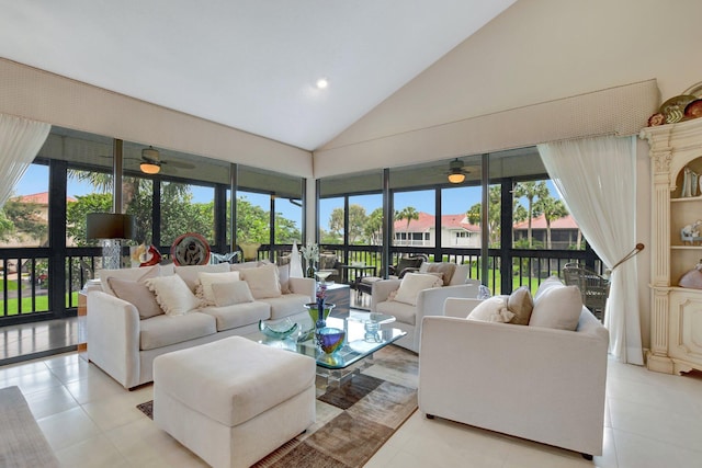 living room featuring a high ceiling, light tile patterned floors, and ceiling fan