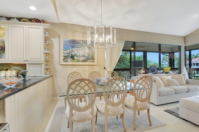 tiled dining space featuring a notable chandelier, sink, and a healthy amount of sunlight