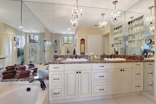 bathroom featuring independent shower and bath, vanity, and tile patterned flooring