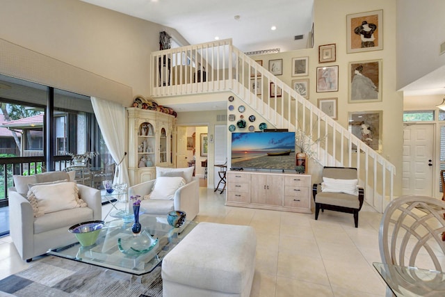 living room with light tile patterned floors and high vaulted ceiling