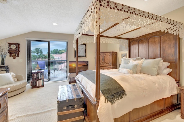 bedroom featuring carpet flooring, vaulted ceiling, a textured ceiling, and access to outside