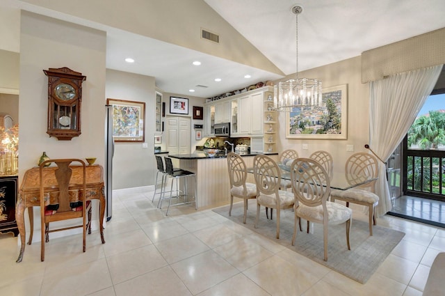 tiled dining area featuring vaulted ceiling and a notable chandelier